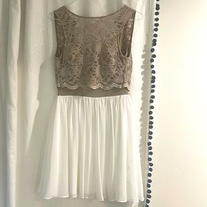 Medium length dress, lacy and sparkly, tan and white colored, built in bra